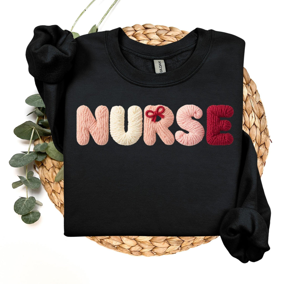 Black sweatshirt with 'NURSE' in colorful letters, faux yarn style on a woven surface.
