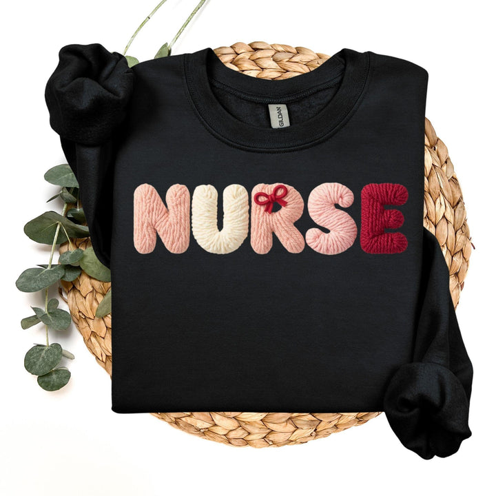 Black sweatshirt with 'NURSE' in colorful letters, faux yarn style on a woven surface.